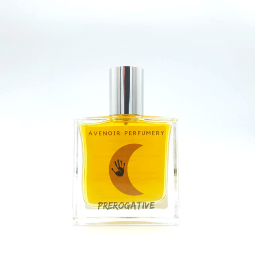 A clear perfume bottle containing a yellow perfume, with the name and crescent moon with a hand print inside the moon