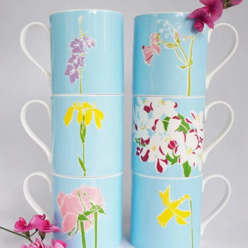 six fine bone china flowers mugs, each featuring a different English flower against a blue background.