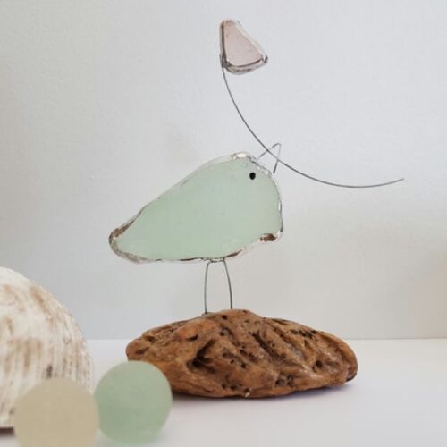 Sea glass bird on a piece of driftwood