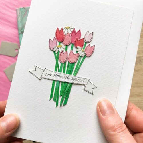 Image of a pair of hands holding a greetings card with handmade tulips and flowers with a banner saying for Someone Special
