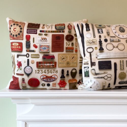 Two cushions on a mantle piece. One red and the other black & white cushions