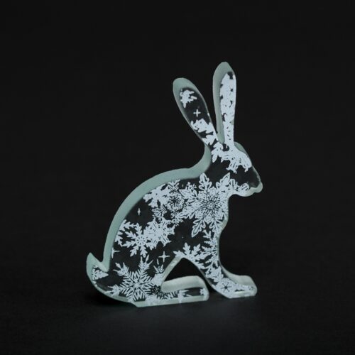 Clear glass hare, screen-printed with white enamel snowflakes.