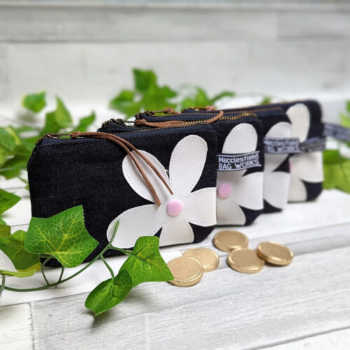 Three recycled denim purses with daisy motif