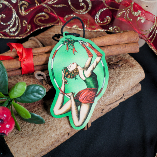 Christmas decoration of a vintage circus aerial hoop performer. Red and green colour theme.